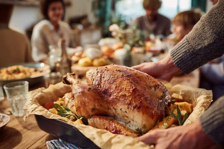 Fresh out of the oven turkey placed on Thanksgiving family dinner table