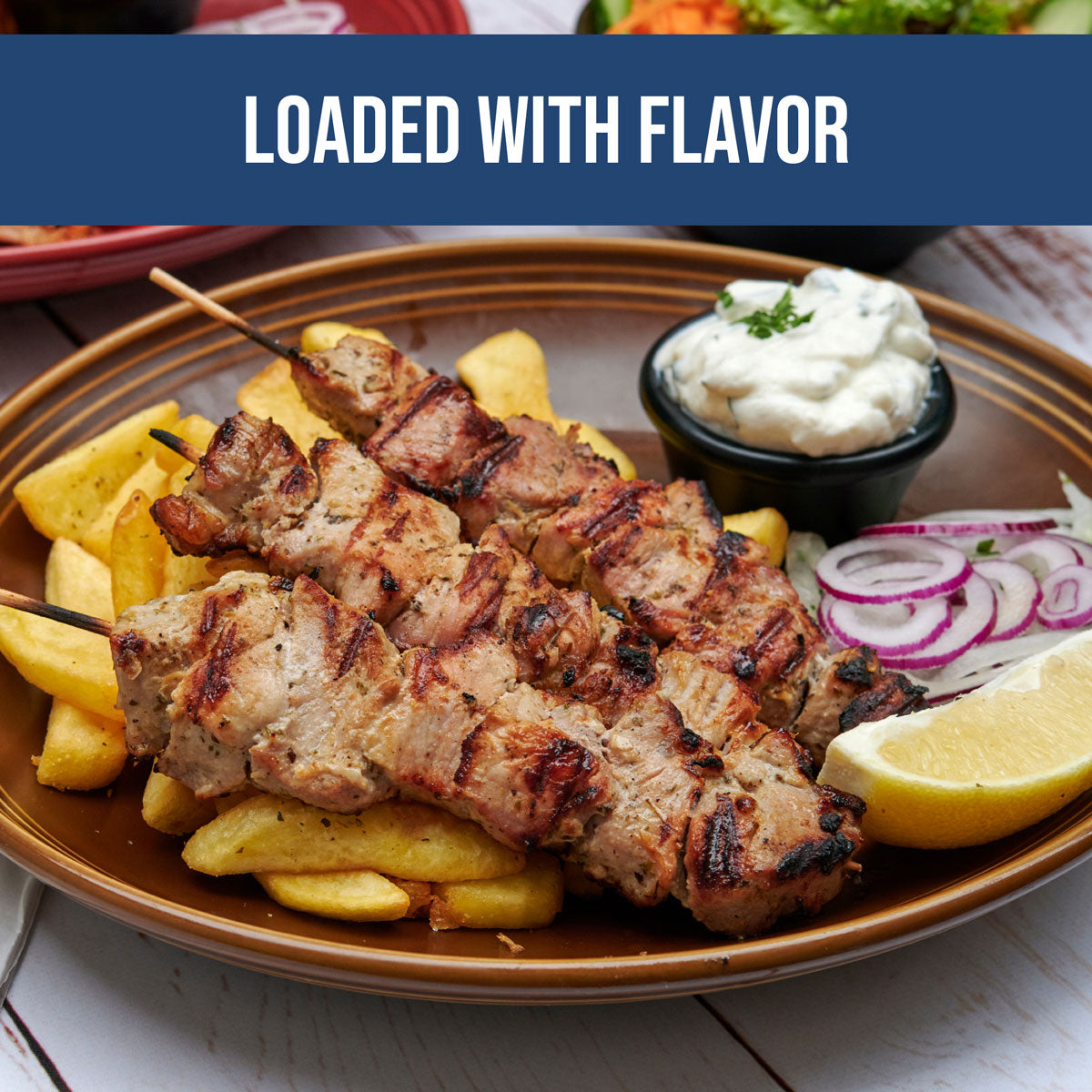 chicken kabobs with organic greek tzatziki, potato wedges and onion for a healthy mediterranean diet