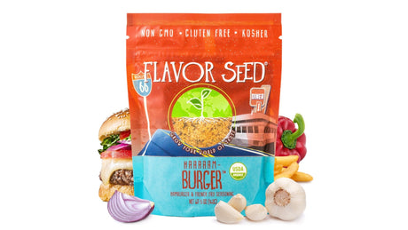 A Flavor Seed HAAAAAM-Burger organic hamburger and french fry seasoning pouch on a white background, with a cheeseburger, a pile of french fries, a red bell pepper, a garlic bulb and cloves and half a red onion around it.
