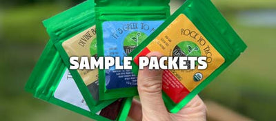 hand fanning out four sample packets of organic seasoning