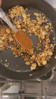 Rock Yo' Taco organic taco seasoning spooned into browned ground beef in a skillet for taco night