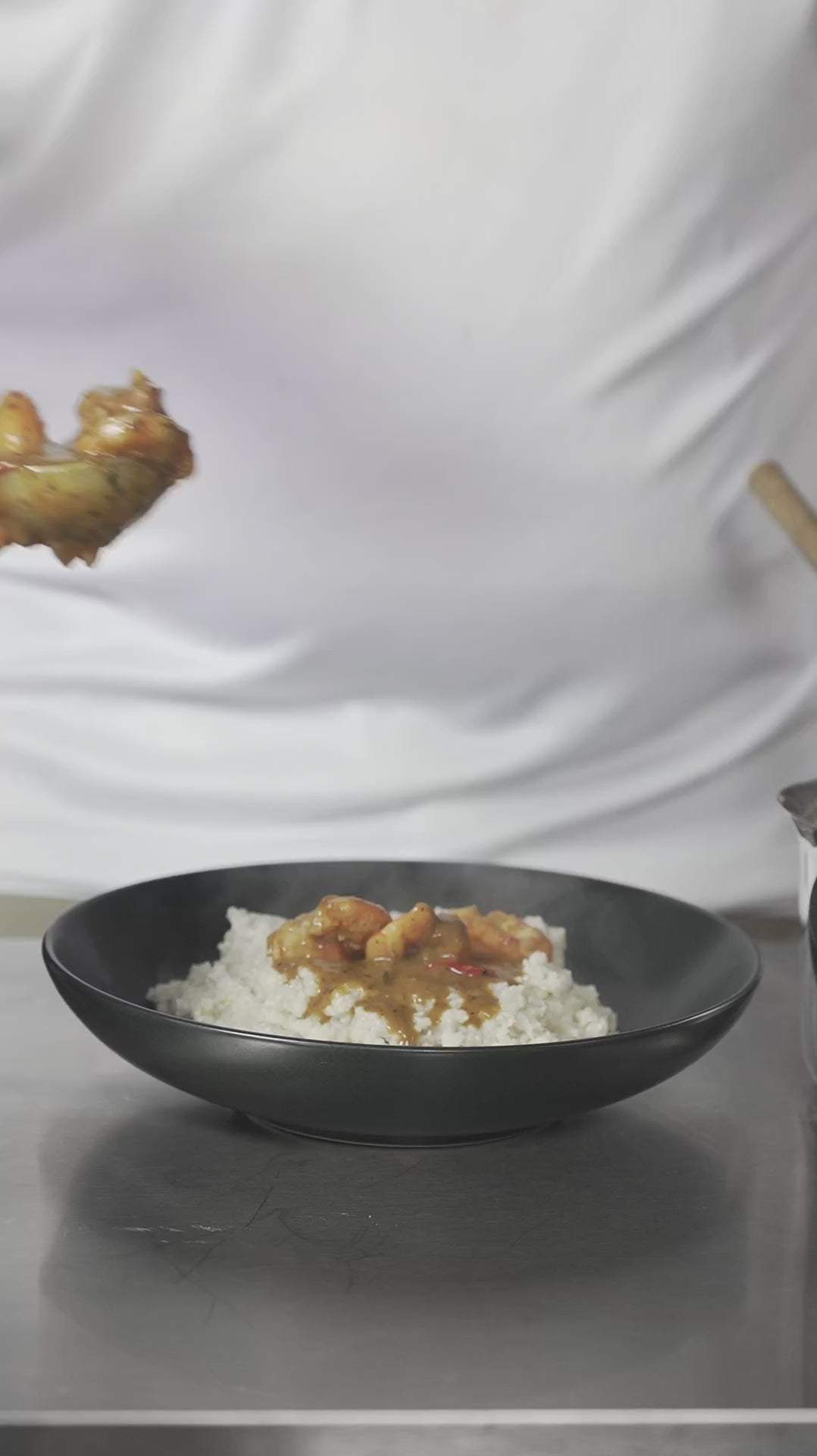 Tidewater organic seafood seasoning in a shrimp sauce ladled over rice
